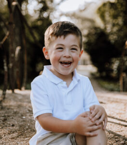 little boy laughing at an outdoor location at the UL Alumni Center in Lafayette LA